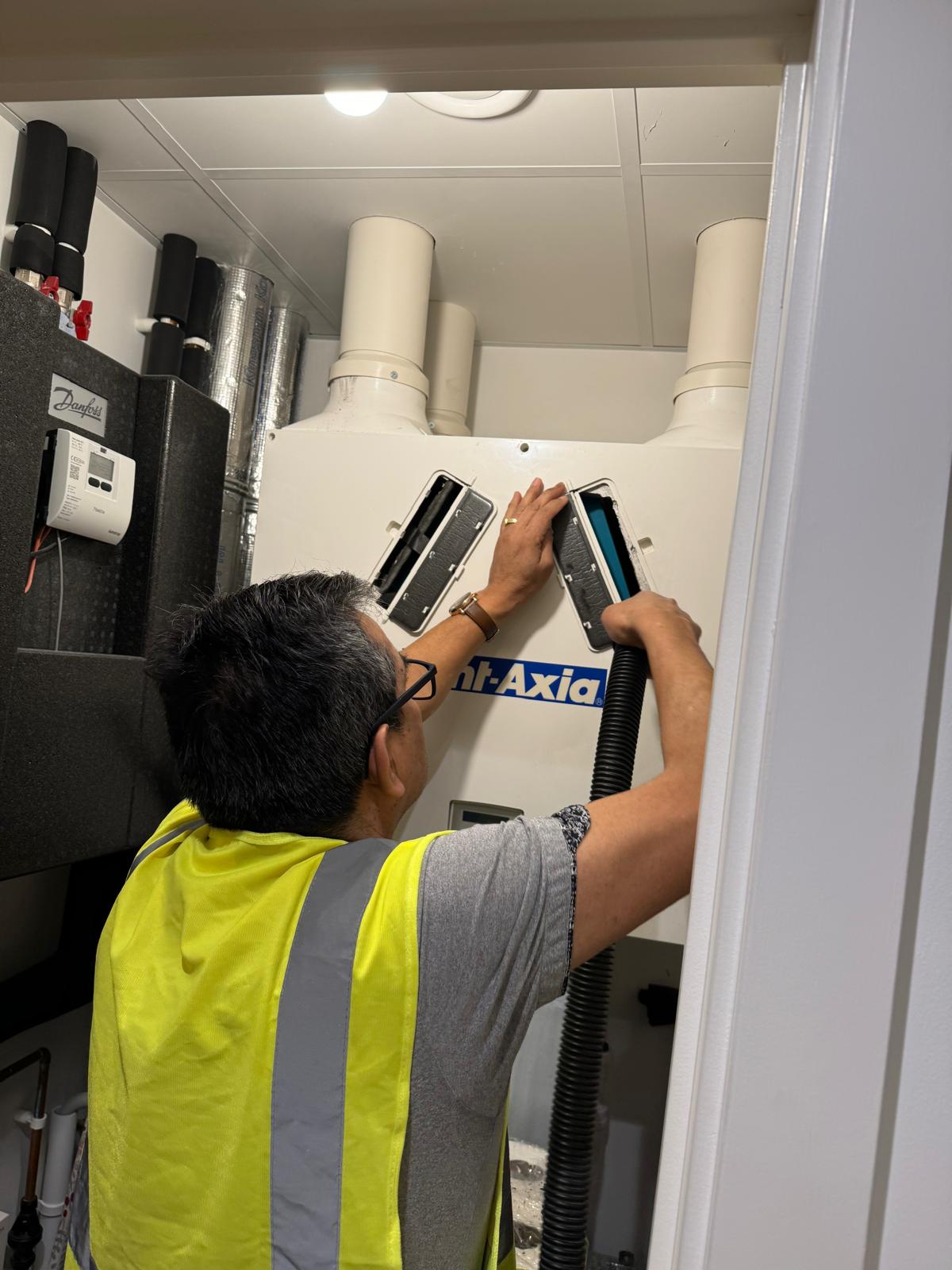 Engineer servicing MVHR unit in London